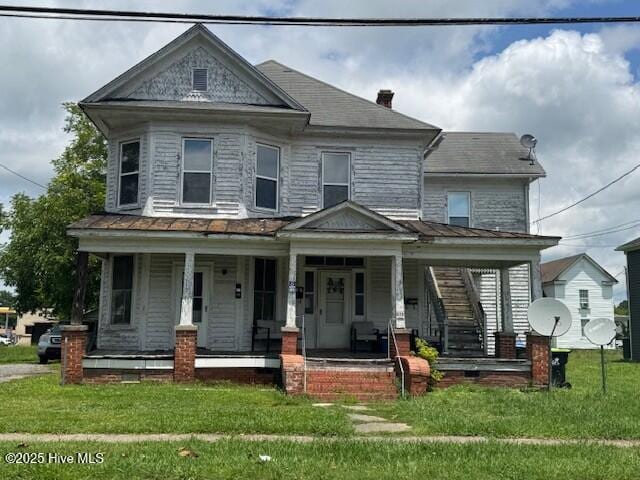 415 E Church St Apt C, Ahoskie, NC 27910 - victorian-style house with covered porch and a front lawn