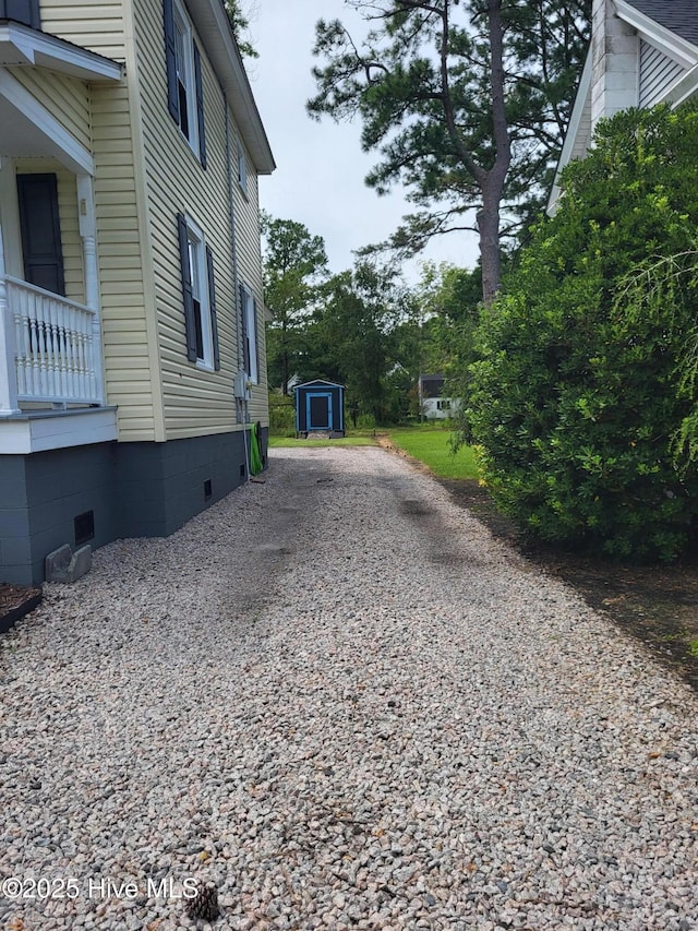 550 E Pungo St, Belhaven, NC 27810 - view of side of property featuring crawl space, a shed, and gravel driveway