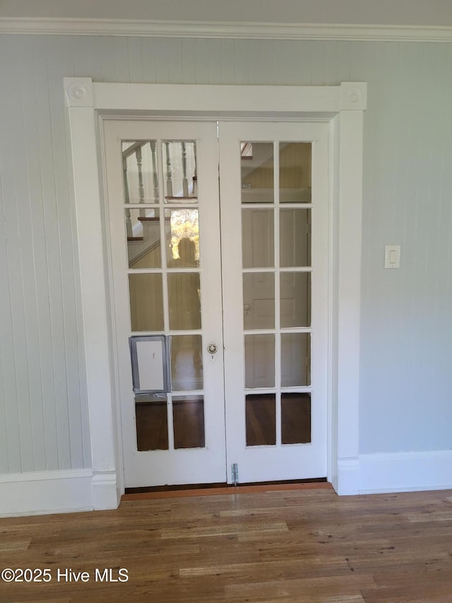 550 E Pungo St, Belhaven, NC 27810 - detailed view of french doors, wood finished floors, ornamental molding, and wood walls