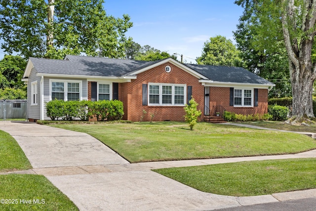 502 N 25th St, Wilmington, NC 28405 - view of front of home featuring a front lawn, driveway, brick siding, and roof with shingles