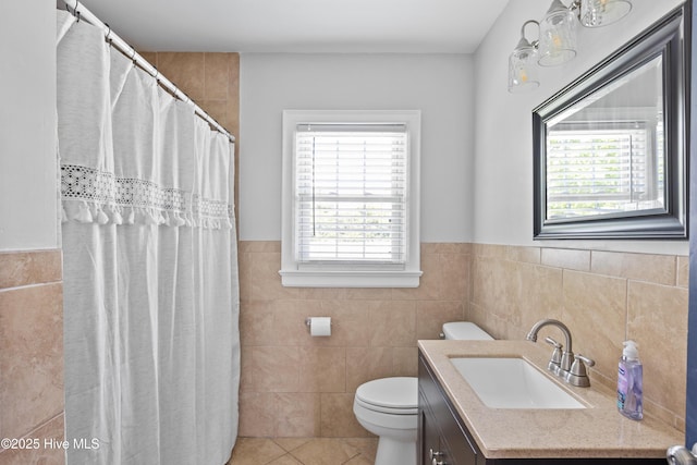 502 N 25th St, Wilmington, NC 28405 - full bath featuring tile walls, tile patterned flooring, vanity, wainscoting, and a shower with curtain