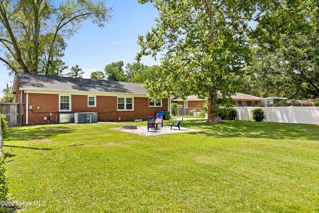 502 N 25th St, Wilmington, NC 28405 - rear view of house featuring a fire pit, a fenced backyard, crawl space, brick siding, and a patio area