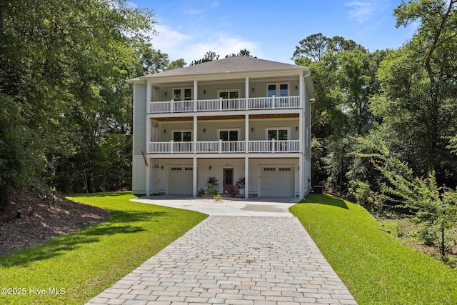 8805 Sound View Ct, Emerald Isle, NC 28594 - view of front of house featuring a balcony, a garage, decorative driveway, and a front yard
