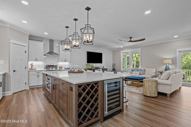 8805 Sound View Ct, Emerald Isle, NC 28594 - kitchen with wine cooler, wall chimney exhaust hood, open floor plan, plenty of natural light, and recessed lighting