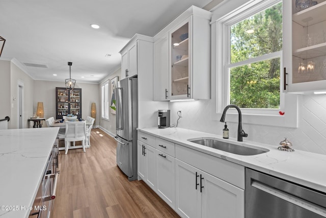 8805 Sound View Ct, Emerald Isle, NC 28594 - kitchen featuring appliances with stainless steel finishes, white cabinetry, healthy amount of natural light, decorative backsplash, and recessed lighting