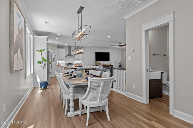8805 Sound View Ct, Emerald Isle, NC 28594 - dining room featuring light wood finished floors, recessed lighting, ceiling fan, and a chandelier