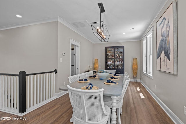 8805 Sound View Ct, Emerald Isle, NC 28594 - dining area featuring wood finished floors, a chandelier, recessed lighting, and ornamental molding