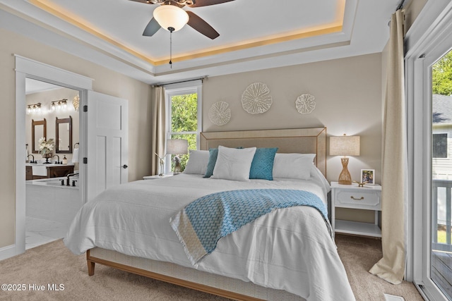 8805 Sound View Ct, Emerald Isle, NC 28594 - bedroom featuring carpet floors, multiple windows, a raised ceiling, and ensuite bathroom