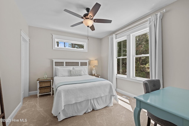 8805 Sound View Ct, Emerald Isle, NC 28594 - carpeted bedroom with baseboards and a ceiling fan