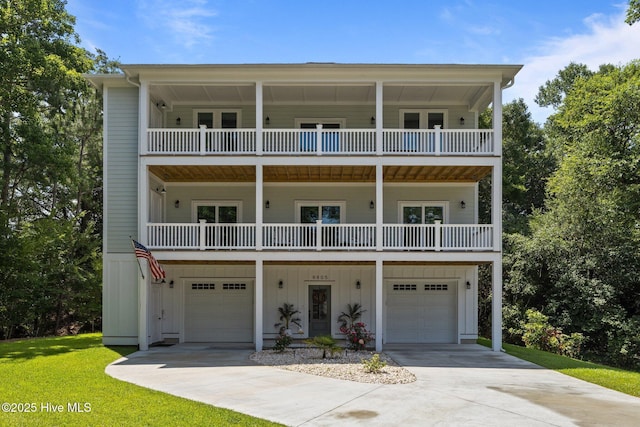 8805 Sound View Ct, Emerald Isle, NC 28594 - coastal home featuring board and batten siding, a balcony, an attached garage, and concrete driveway
