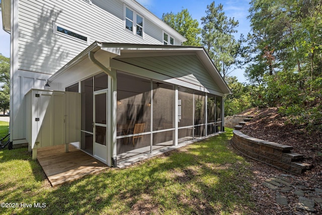 8805 Sound View Ct, Emerald Isle, NC 28594 - rear view of property featuring a sunroom and a lawn