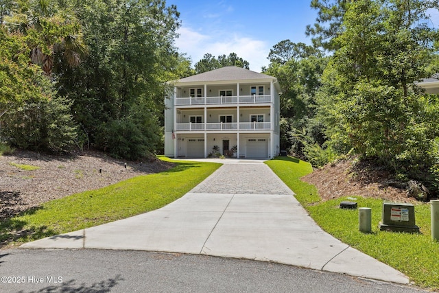 8805 Sound View Ct, Emerald Isle, NC 28594 - view of front of house with a balcony, a garage, driveway, and a front lawn