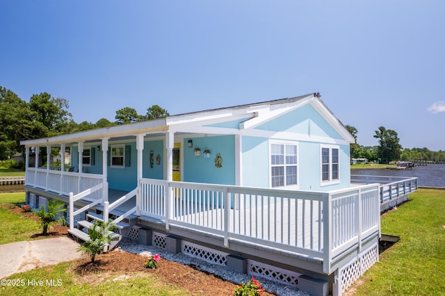 124 Holiday Knl, Hertford, NC 27944 - view of front of home featuring a front yard, a porch, and a water view