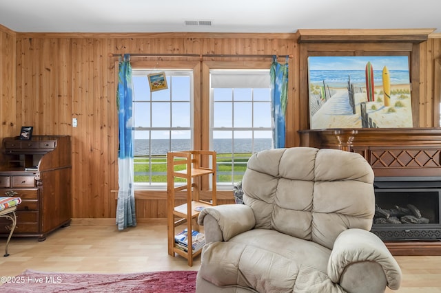 124 Holiday Knl, Hertford, NC 27944 - sitting room with wood finished floors, wooden walls, and a water view