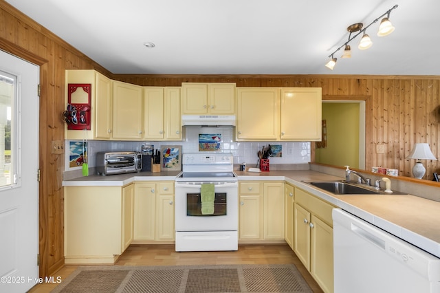 124 Holiday Knl, Hertford, NC 27944 - kitchen featuring white appliances, under cabinet range hood, wooden walls, tasteful backsplash, and light countertops
