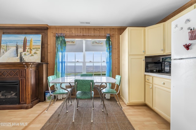 124 Holiday Knl, Hertford, NC 27944 - dining area with light wood finished floors, wooden walls, and a fireplace