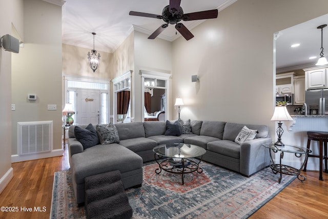 404 River Birch Dr, Greenville, NC 27858 - living area featuring crown molding, a ceiling fan, light wood-type flooring, recessed lighting, and a towering ceiling