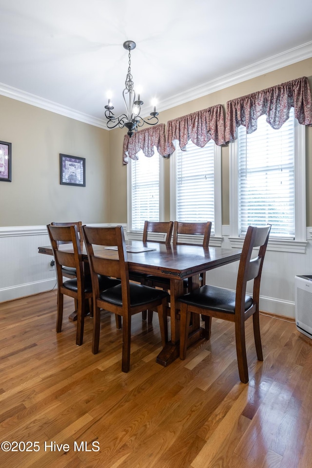 404 River Birch Dr, Greenville, NC 27858 - dining area featuring ornamental molding, a chandelier, a wainscoted wall, and light wood finished floors