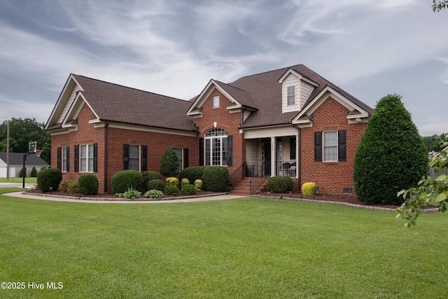 404 River Birch Dr, Greenville, NC 27858 - view of front of home with brick siding, roof with shingles, a front yard, and covered porch