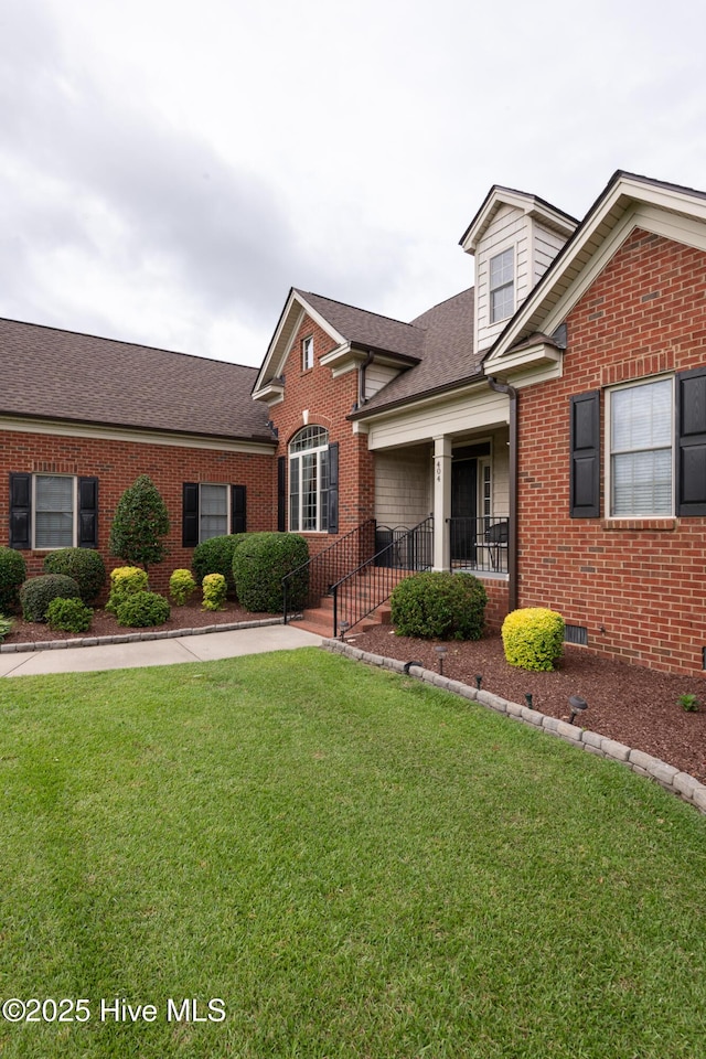 404 River Birch Dr, Greenville, NC 27858 - traditional home with brick siding, a front lawn, and roof with shingles