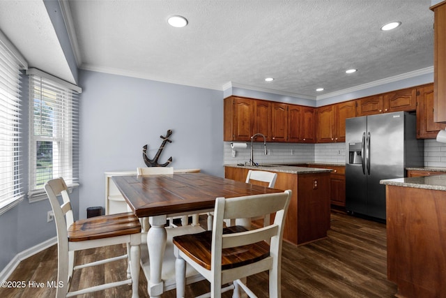 5023 Marathon Landing Ct, Castle Hayne, NC 28429 - kitchen featuring stainless steel fridge, a textured ceiling, decorative backsplash, dark wood-style floors, and brown cabinetry