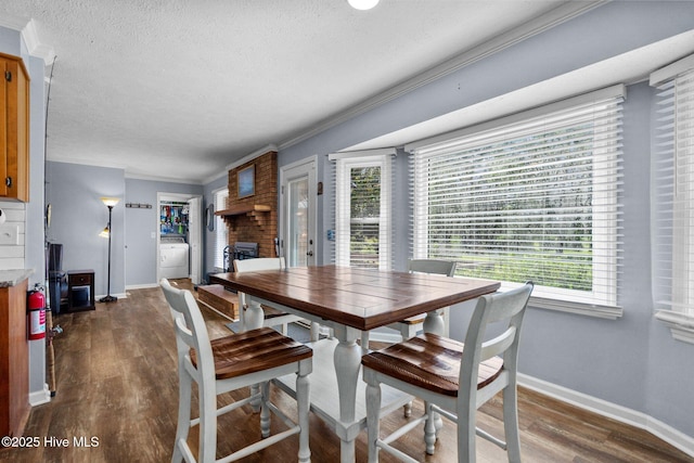 5023 Marathon Landing Ct, Castle Hayne, NC 28429 - dining room featuring washer / dryer, healthy amount of natural light, a brick fireplace, dark wood-style floors, and a textured ceiling