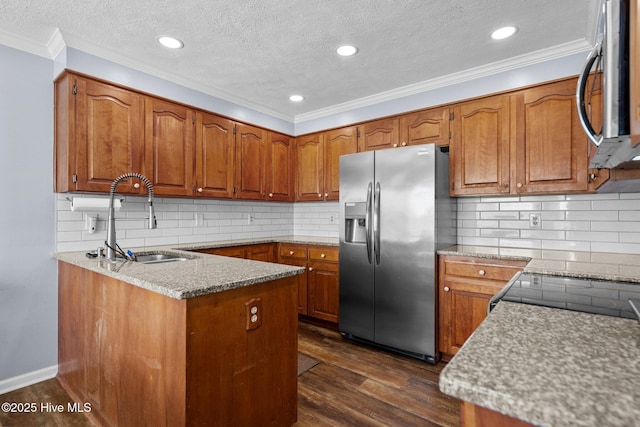 5023 Marathon Landing Ct, Castle Hayne, NC 28429 - kitchen featuring stainless steel appliances, brown cabinetry, a peninsula, dark wood-style flooring, and ornamental molding