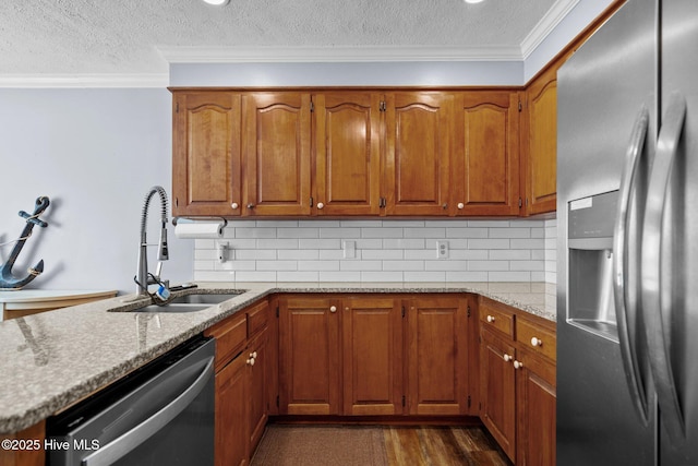5023 Marathon Landing Ct, Castle Hayne, NC 28429 - kitchen featuring appliances with stainless steel finishes, a textured ceiling, brown cabinetry, ornamental molding, and backsplash