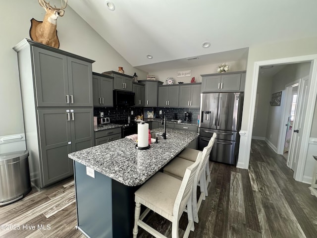 2925 Davenport Rd, Deep Run, NC 28525 - kitchen with stainless steel fridge, gray cabinetry, decorative backsplash, light stone countertops, and black microwave