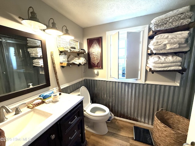 200 Carolina Beach Ave S, Carolina Beach, NC 28428 - full bath featuring wood finished floors, vanity, a wainscoted wall, a textured ceiling, and a shower
