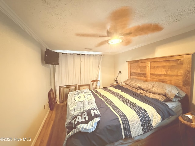 200 Carolina Beach Ave S, Carolina Beach, NC 28428 - bedroom with a textured ceiling, wood finished floors, crown molding, and a ceiling fan