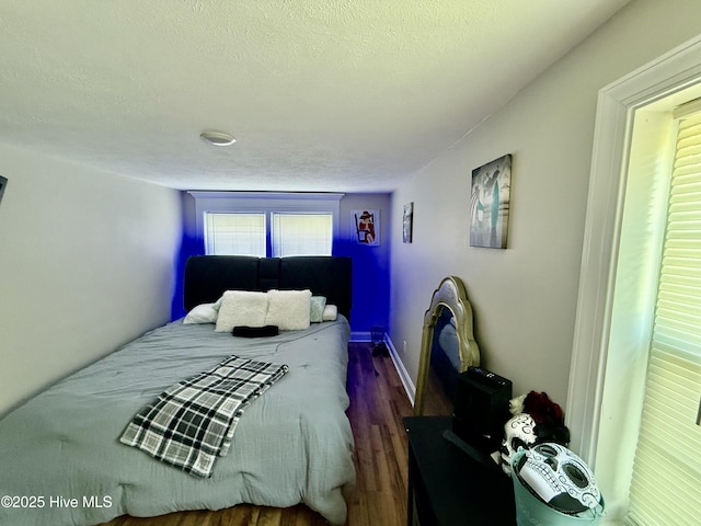 200 Carolina Beach Ave S, Carolina Beach, NC 28428 - bedroom with wood finished floors and a textured ceiling