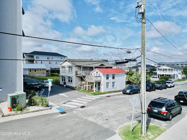 200 Carolina Beach Ave S, Carolina Beach, NC 28428 - view of asphalt street featuring sidewalks, a residential view, and traffic signs