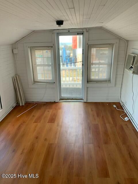 200 Carolina Beach Ave S, Carolina Beach, NC 28428 - doorway to outside featuring lofted ceiling, wood finished floors, and wood walls