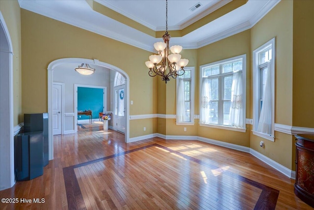 100 Knollwood Ct, New Bern, NC 28562 - unfurnished dining area featuring arched walkways, hardwood / wood-style flooring, a chandelier, and crown molding