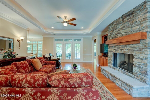 100 Knollwood Ct, New Bern, NC 28562 - living room featuring a tray ceiling, a ceiling fan, light wood-type flooring, ornamental molding, and a fireplace