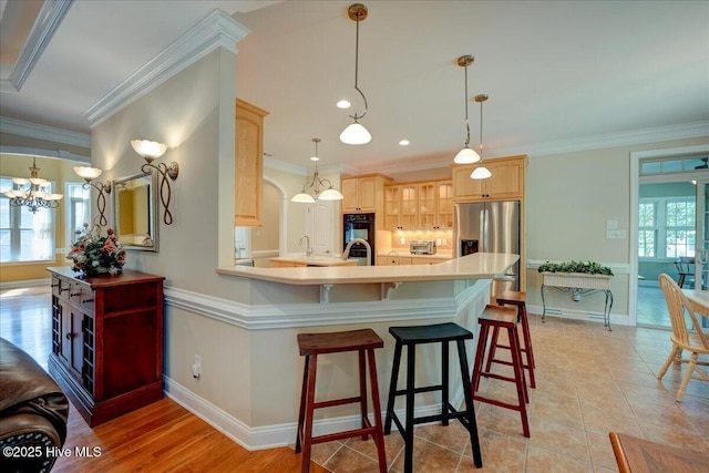 100 Knollwood Ct, New Bern, NC 28562 - kitchen featuring light brown cabinets, stainless steel fridge, a peninsula, a breakfast bar, and light countertops