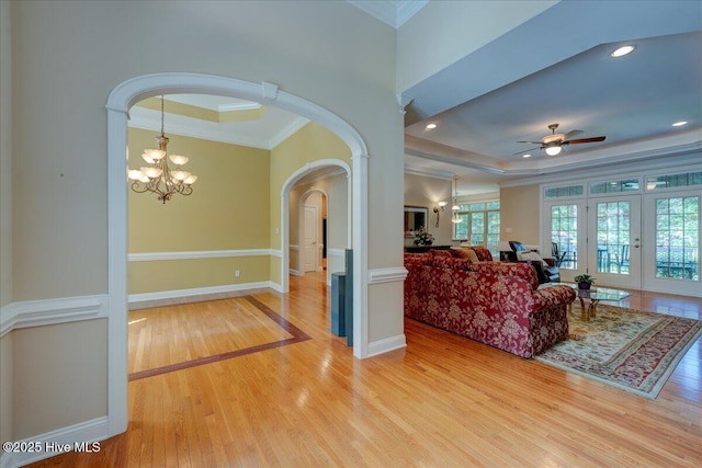 100 Knollwood Ct, New Bern, NC 28562 - living area featuring arched walkways, ornamental molding, light wood-type flooring, a ceiling fan, and a raised ceiling
