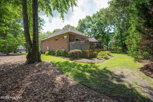 100 Knollwood Ct, New Bern, NC 28562 - view of property exterior featuring brick siding, a deck, and a yard