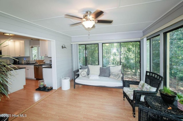 254 W Devonshire Ave, West End, NC 27376 - living area featuring ceiling fan, light wood-style floors, and ornamental molding