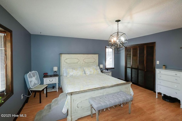 254 W Devonshire Ave, West End, NC 27376 - bedroom featuring a chandelier and light wood finished floors