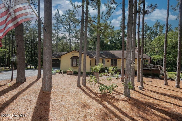 254 W Devonshire Ave, West End, NC 27376 - view of front of house with a wooden deck and view of scattered trees