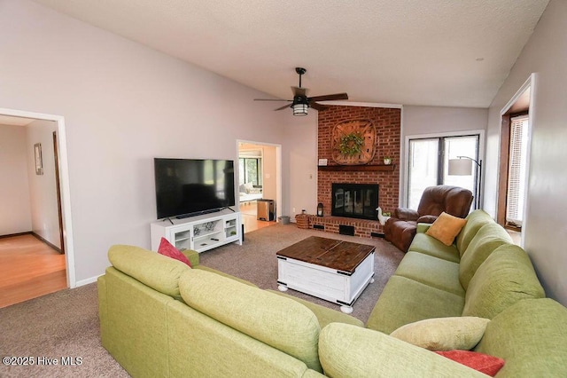 254 W Devonshire Ave, West End, NC 27376 - carpeted living room featuring lofted ceiling, a ceiling fan, and a fireplace