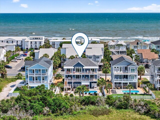 277 E Second St, Ocean Isle Beach, NC 28469 - aerial perspective of suburban area with a pool and a large body of water