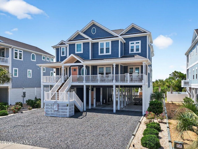 277 E Second St, Ocean Isle Beach, NC 28469 - coastal home with a carport, driveway, a porch, and stairway