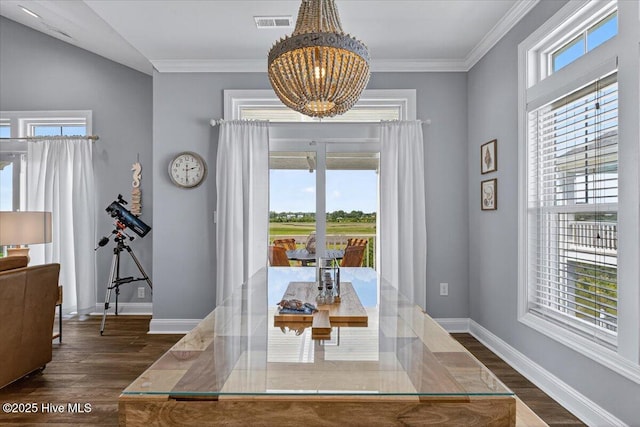 277 E Second St, Ocean Isle Beach, NC 28469 - dining area featuring a chandelier, dark wood-type flooring, and crown molding
