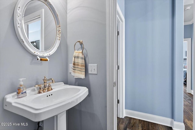 277 E Second St, Ocean Isle Beach, NC 28469 - bathroom featuring a sink and wood finished floors