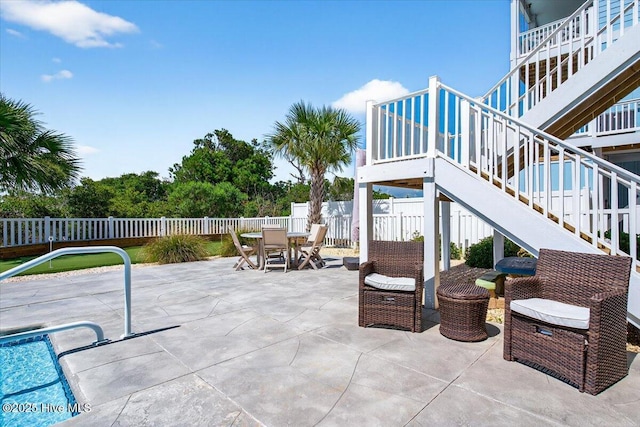277 E Second St, Ocean Isle Beach, NC 28469 - fenced backyard featuring stairs, outdoor dining space, and a patio area