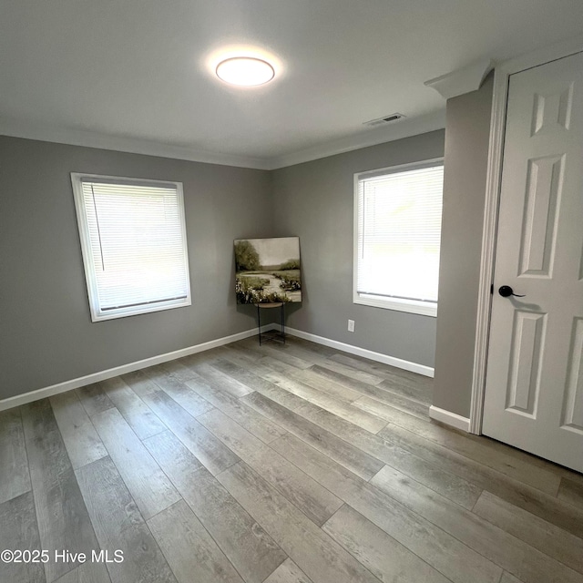 510 S Sycamore St, Fremont, NC 27830 - unfurnished room with ornamental molding, healthy amount of natural light, and wood finished floors