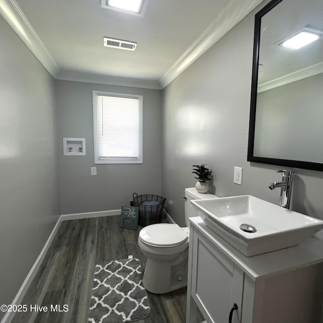 510 S Sycamore St, Fremont, NC 27830 - half bathroom with wood finished floors, crown molding, and vanity